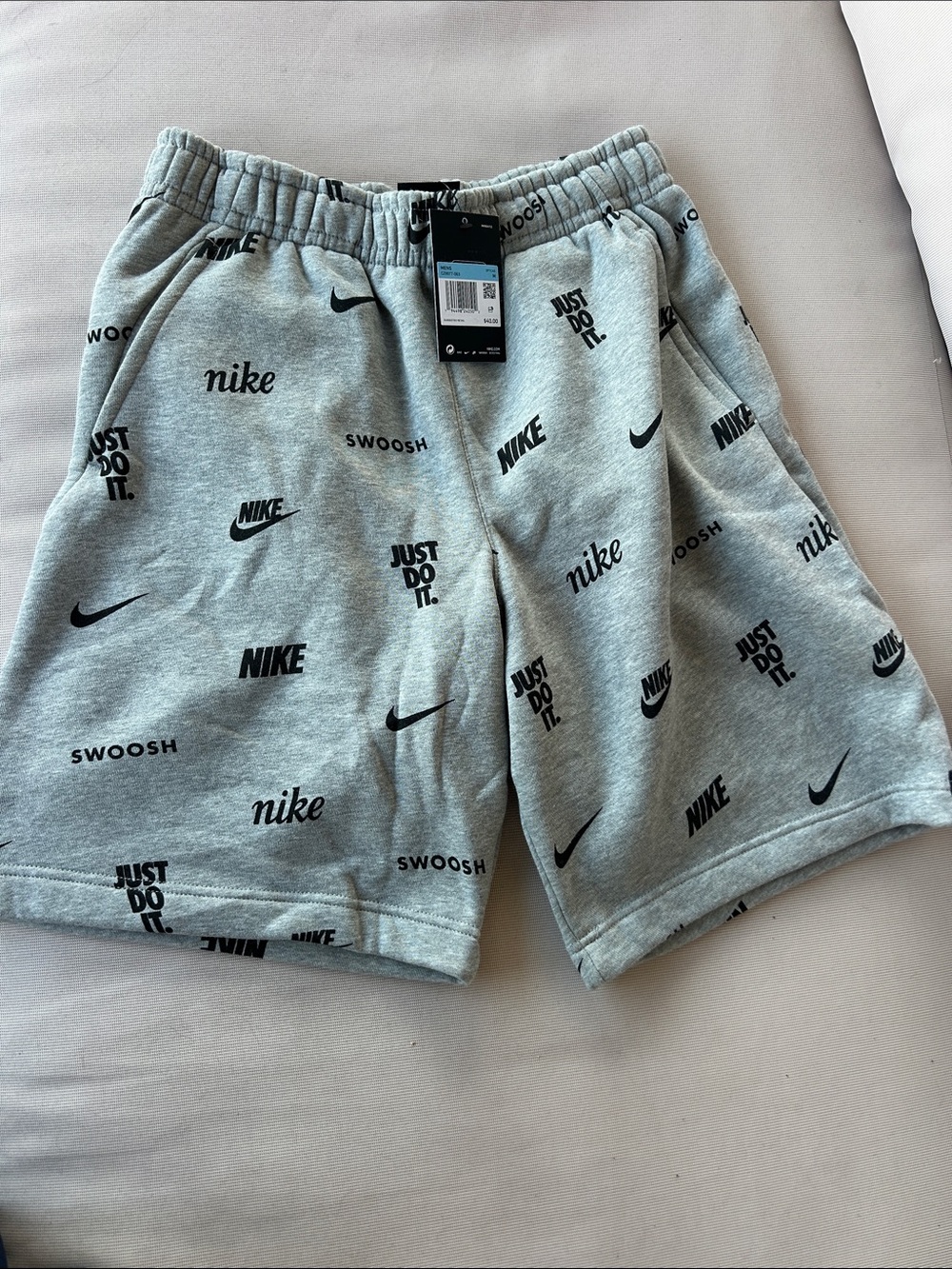 Nike Men’s Light Gray All-Over Logo Athletic Shorts